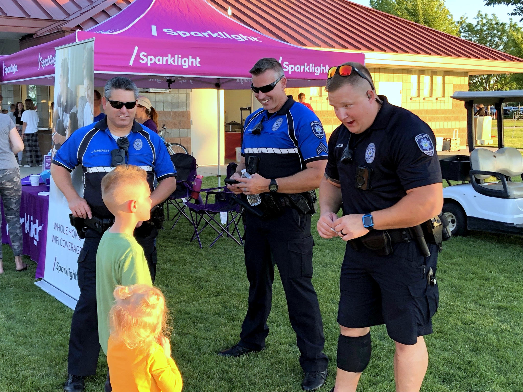 Police taking to youth with Sparklight Movie Night Booth behind them